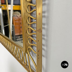 Brass wall mirror with swirl decorated frame, 1940s